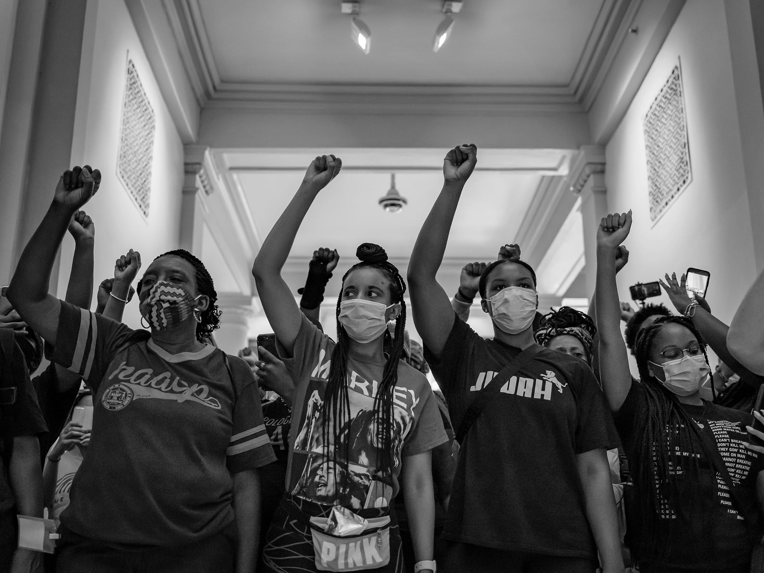 shutterstock_1756949135 Group of young people raise their fist